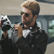 George Michael checks his video camera on a railway station platform in Japan during the Japanese/Australian leg of his Faith World Tour in February 1988.